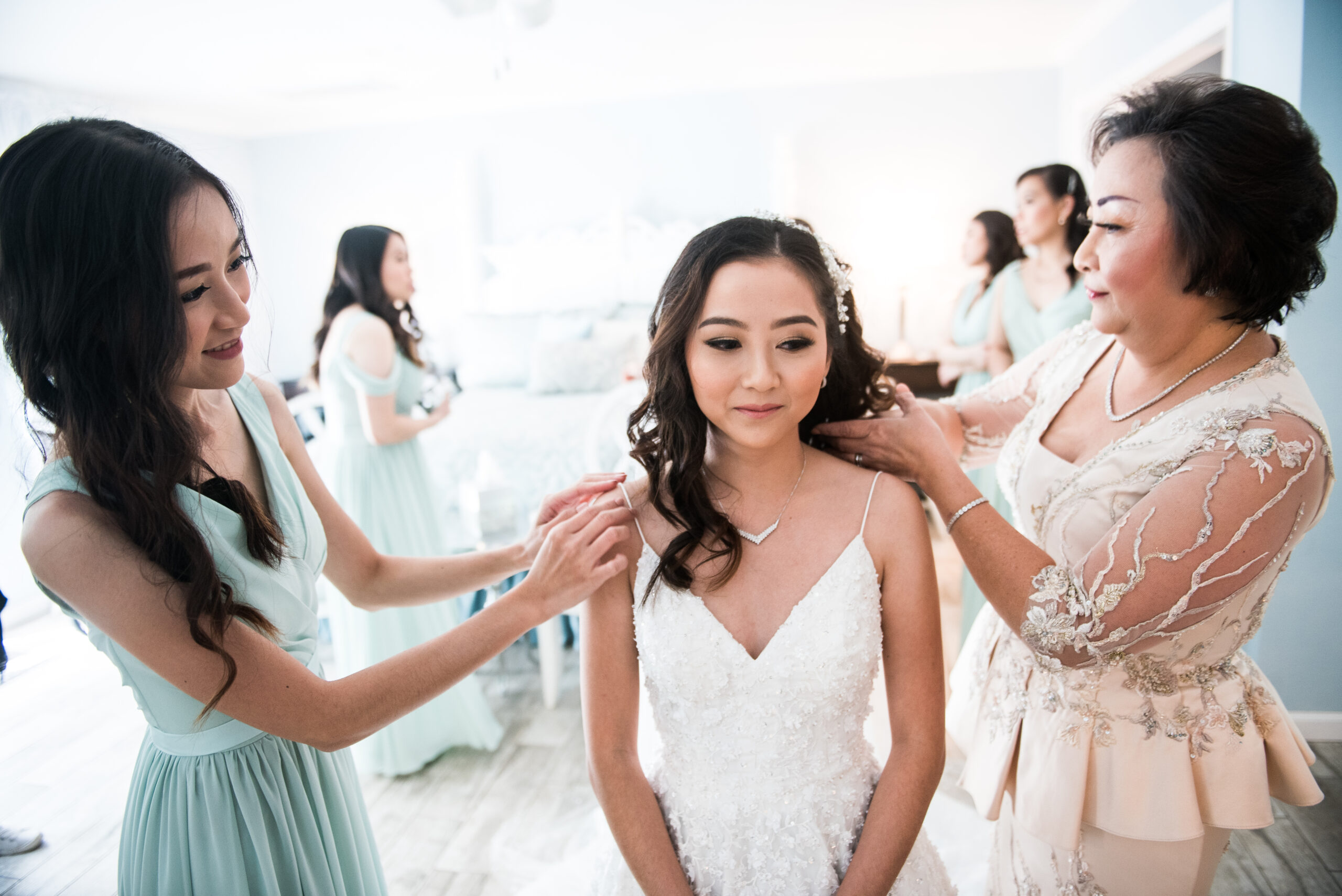 a mother adjusts a brides hair