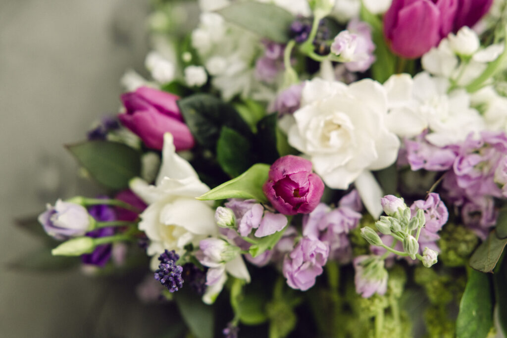 a purple, white, and green bridal bouquet filling the frame