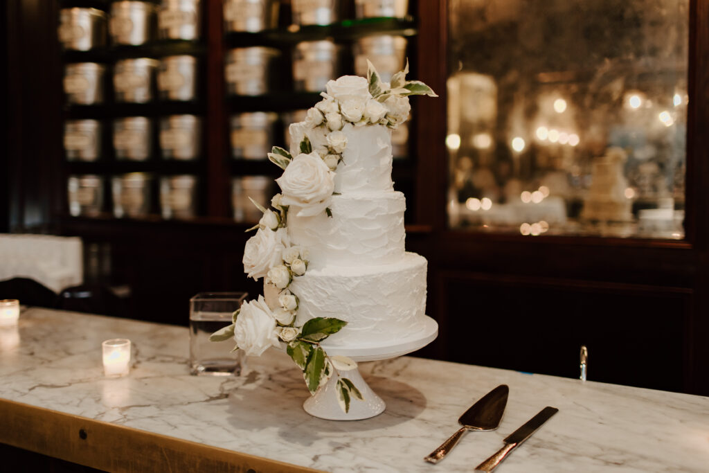 white textured wedding cake on a marble counter
